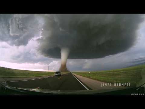 Storm chasing dashcam: Tornado crossing the highway! Laramie, Wyoming