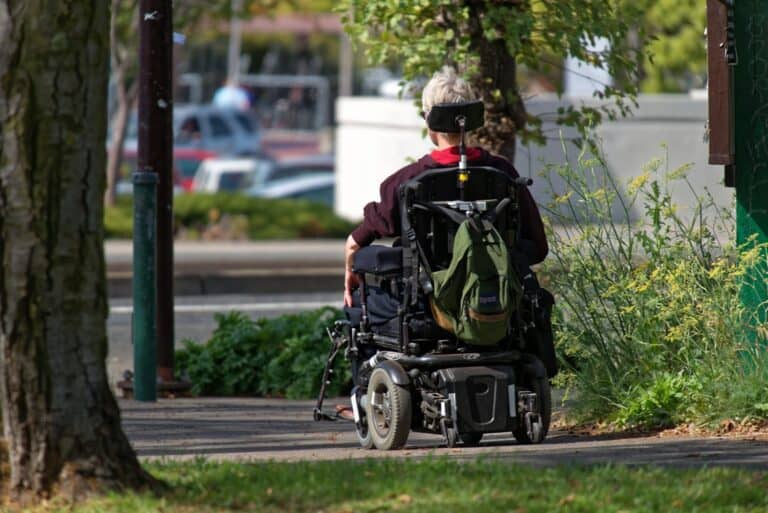 person with backpack in wheel chair