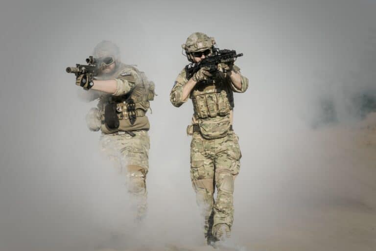 two-soldiers in camo clothing shooting