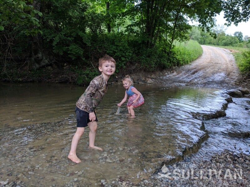 kids on a shallow river bed