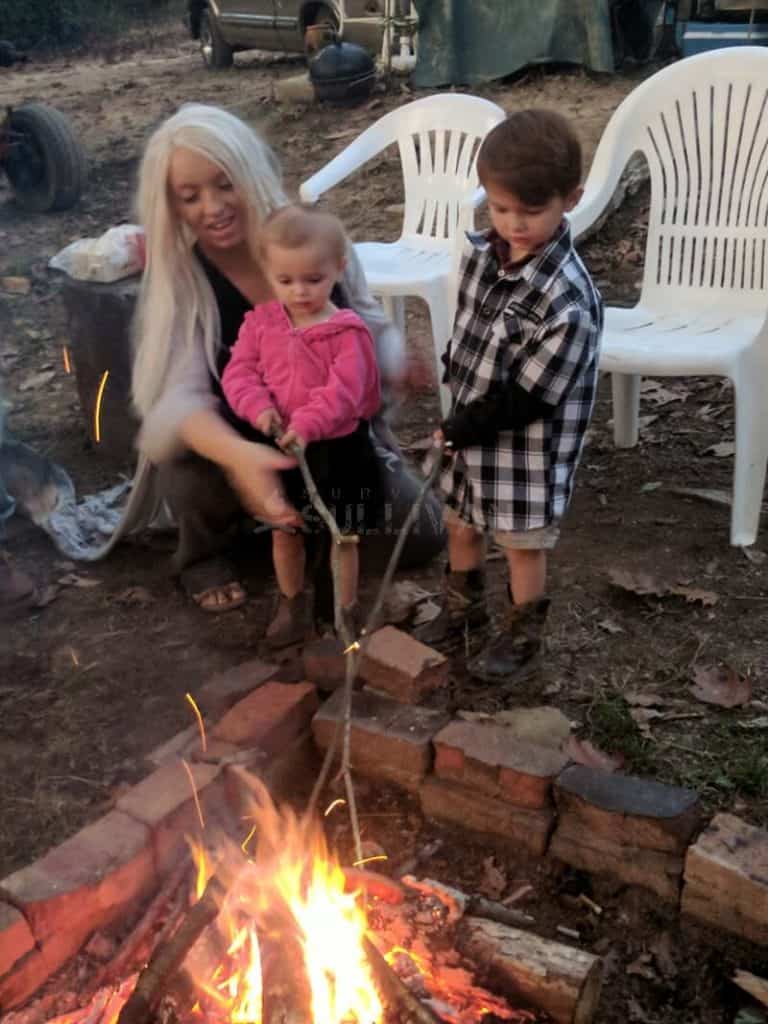 mom and her children doing outdoor cooking
