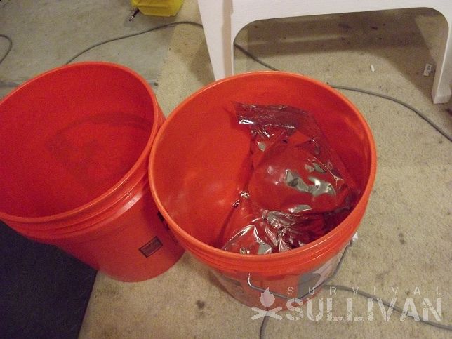 two red buckets with survival food inside