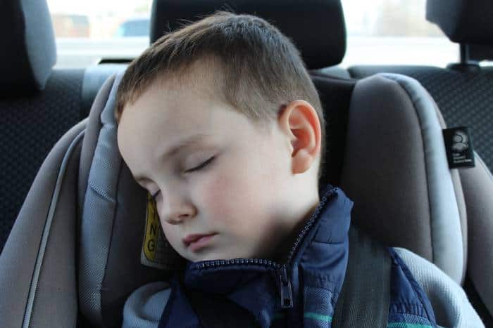 boy sleeping in car