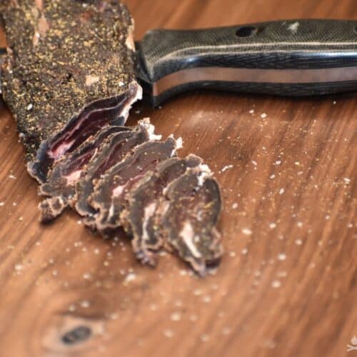 slices of biltong on wooden cutting board
