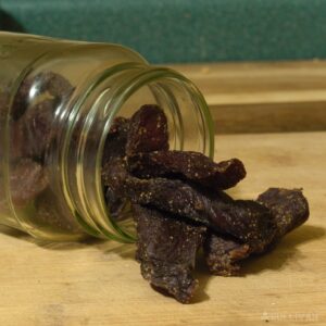 dried beef jerky spilling out of glass jar
