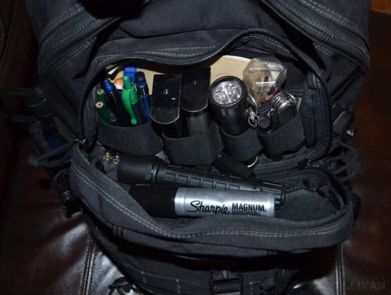open get home bag with flashlights multitool sharpie and pens showing