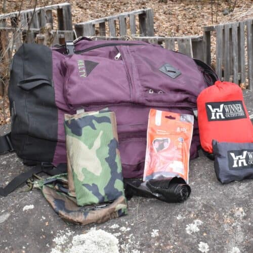 tarps and emergency blanket next to backpack