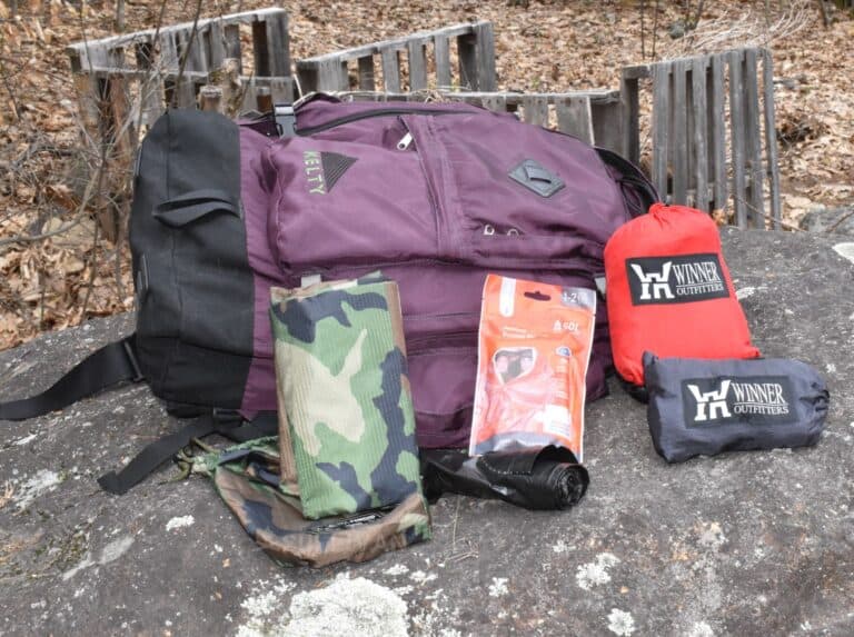 tarps and emergency blanket next to backpack