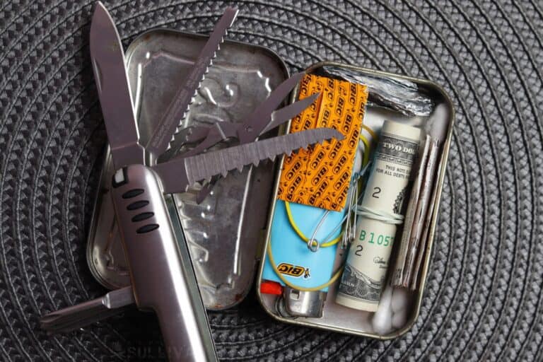 Altoids tin urban survival kit with multi-tool lighter cash and q-tips
