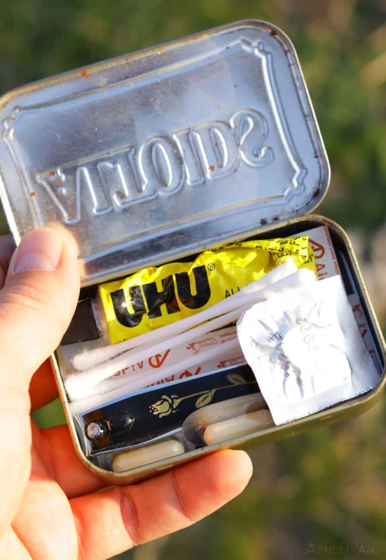 first aid kit items inside an Altoids tin