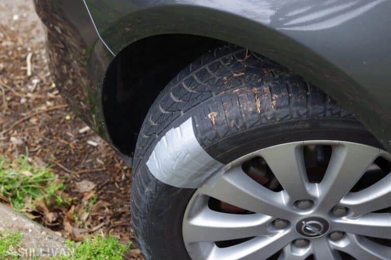 car tire temporarily patched with duct tape