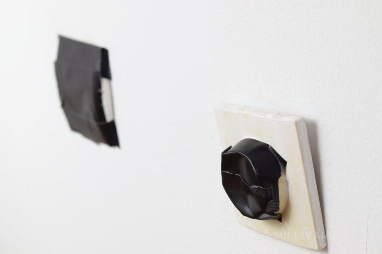 duct tape covering two wall outlets