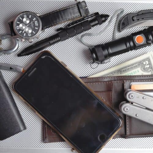 EDC kit: phone, wallet, cash, multi-tool, watch, tactical pen, folding knife
