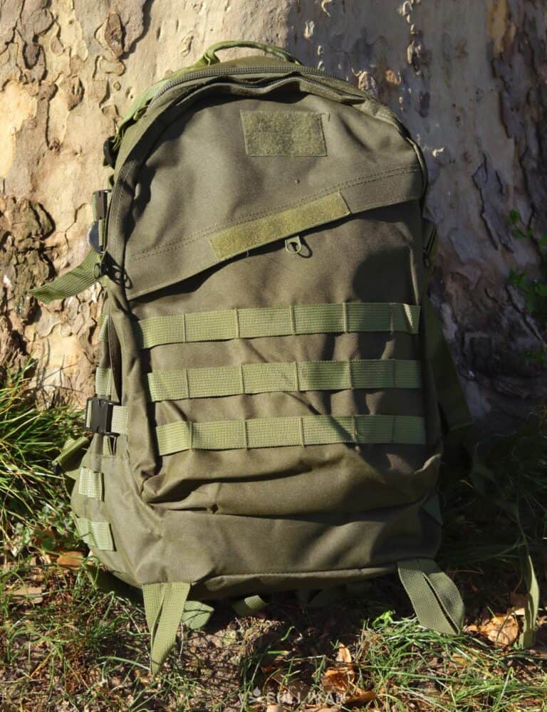 a green backpack with MOLLE webbing