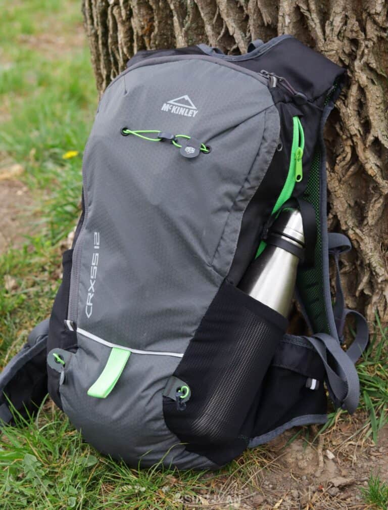 grey backpack with stainless steel water bottle on side pocket