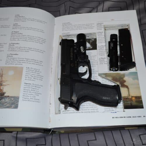hidden gun inside open book (book safe)