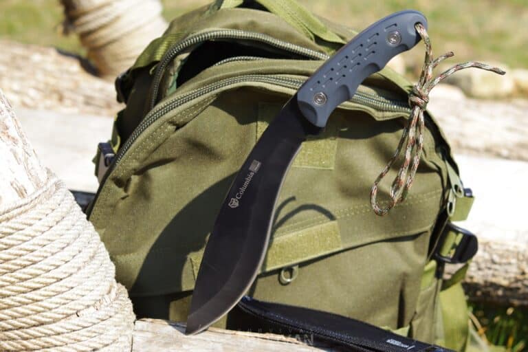 kukri knife next to green backpack