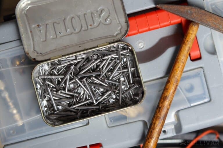 nails inside an Altoids tin next to hammer