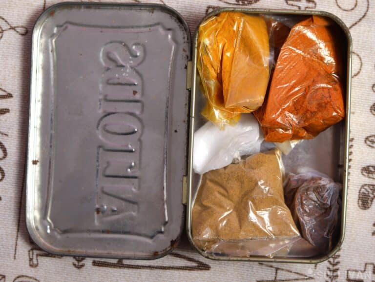 packs of seasonings inside an Altoids tin