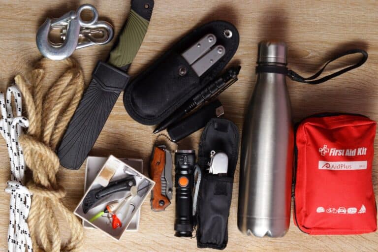 multitool, knife, first aid kit, metal water bottle, carabiner, two types of rope, and fishing gear