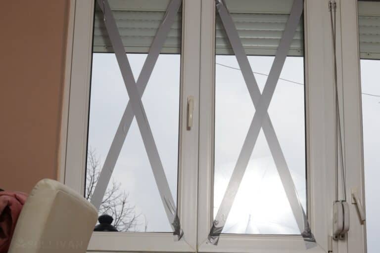 window with duct tape in the shape of an X to prevent shattering