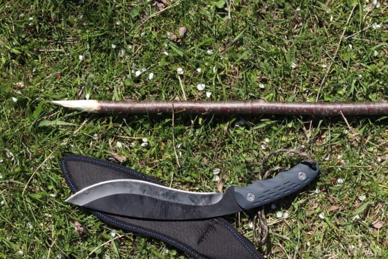 DIY spear from stick next to large knife