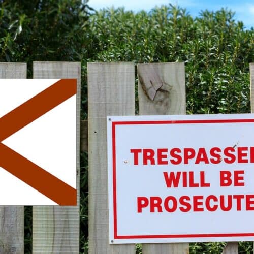 flag of Alabama next to "no trespassing" sign