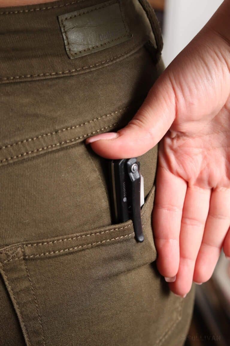 folding knife clipped to girl's jeans back pocket