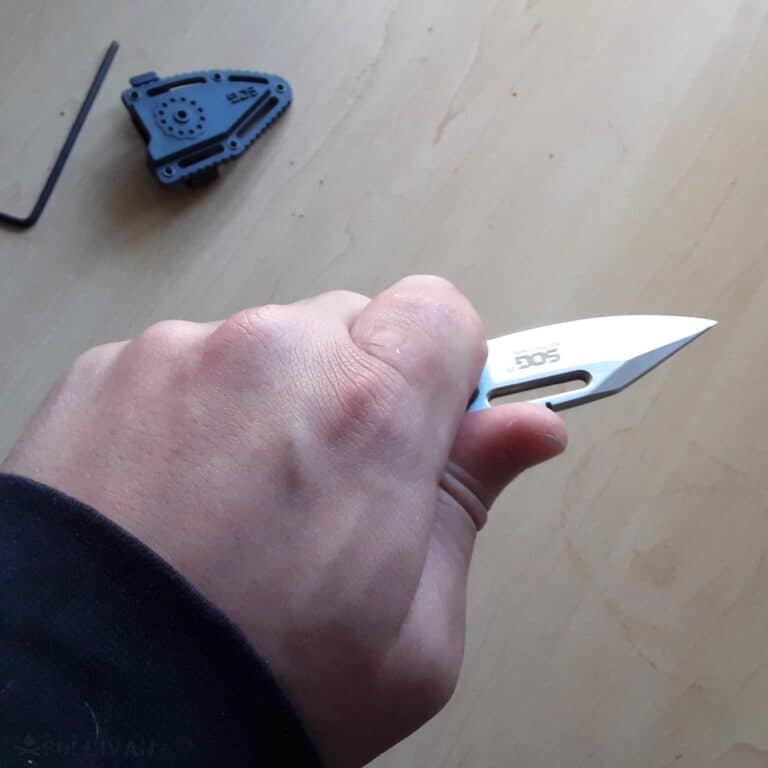 holding the SOG Instinct mini knife in hand