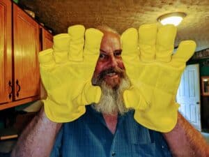 man wearing yellow leather work gloves