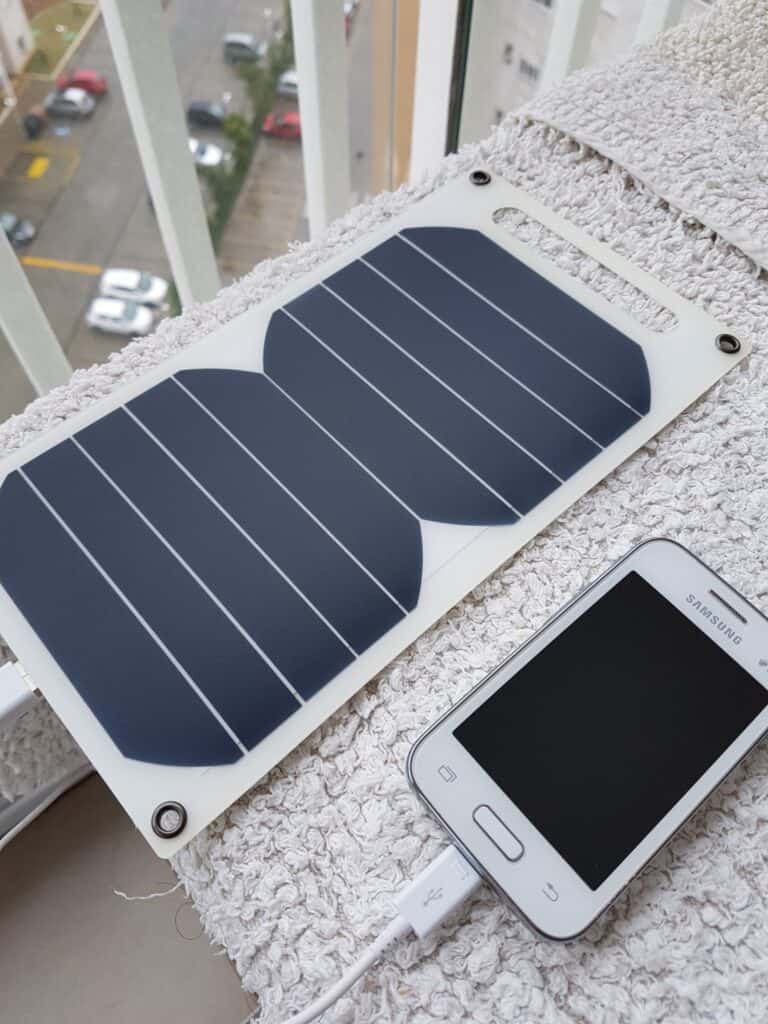 two portable solar panels charging a phone