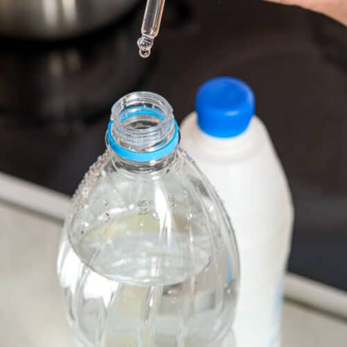 adding bleach to a water bottle