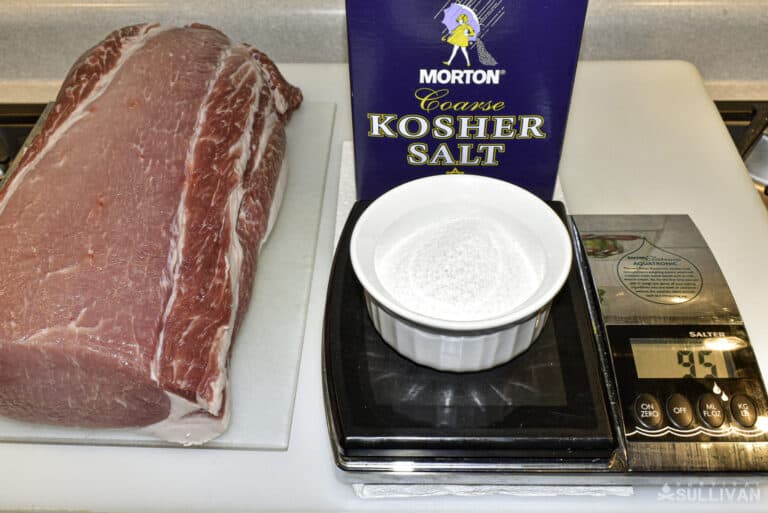 kosher salt on weighing scale next to its box and pork loin
