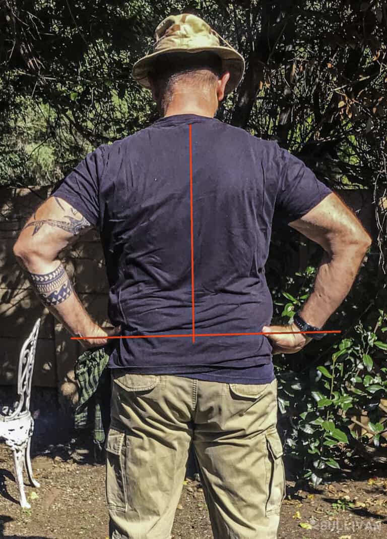 man showing from behind with two lines crossing to show how to fit a backpack