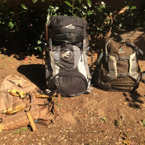 three backpacks a 45 liter frameless day pack a large 7-day pack, and a smaller 2-day pack