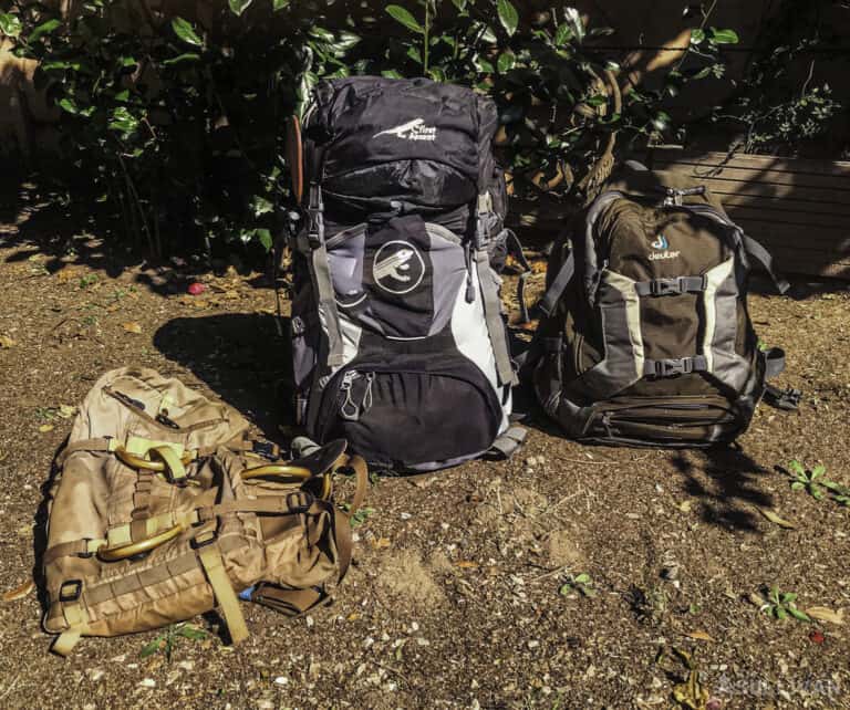 three backpacks a 45 liter frameless day pack a large 7-day pack, and a smaller 2-day pack