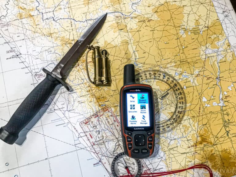 GPS, knife, map compass, and ruler over a topo map