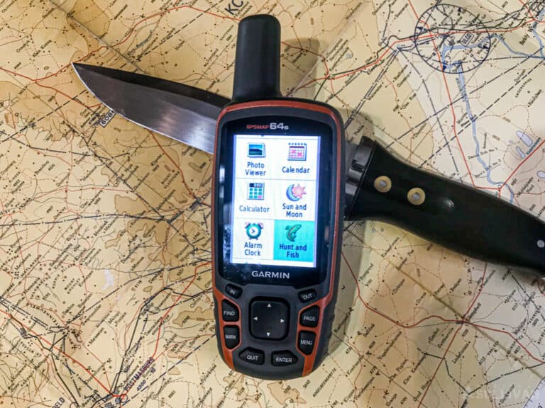 garmin GPS device over a map and a hunting knife