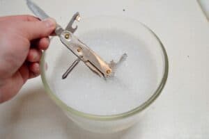 swiss army knife soaked in soapy water