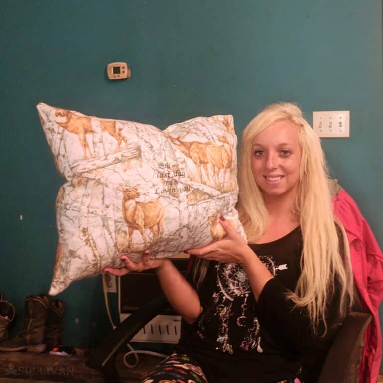 woman with a hand sewn pillow cover