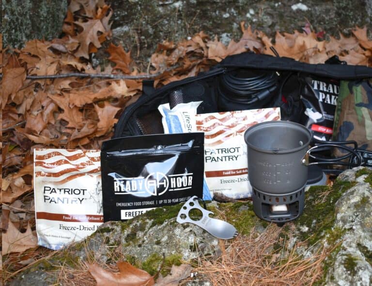 freeze-dried food pouches, from Patriot Pantry and Ready Hour next to rocket stove