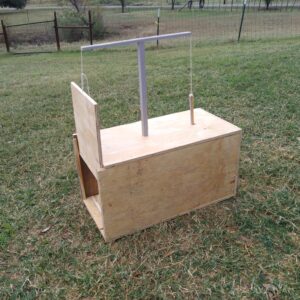 a wooden box raccoon trap