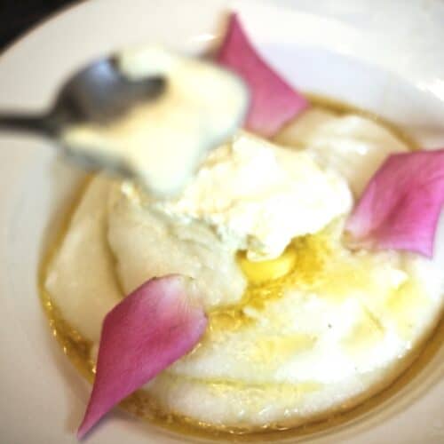 cornmeal mush with a dollop of cream and edible rose petals