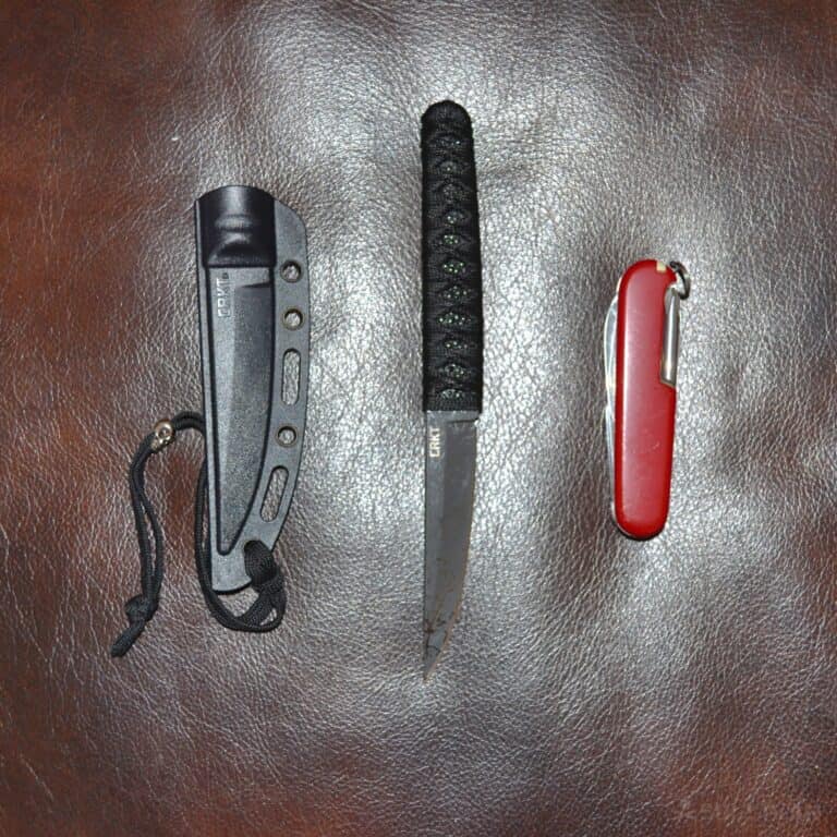 fixed-blade CRKT Obake knife next to a folding Swiss army knife