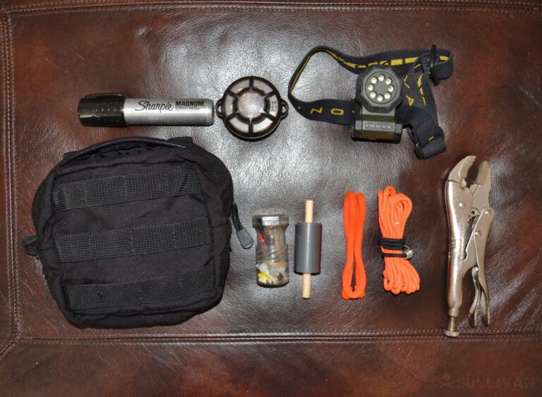 small EDC toolkit and pouch with headlamp pliers cordage and compass