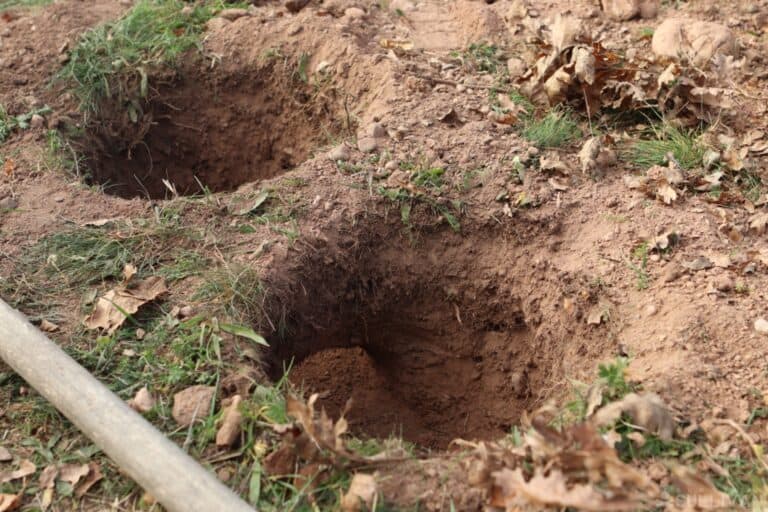 two holes in the ground with a connection tunnel