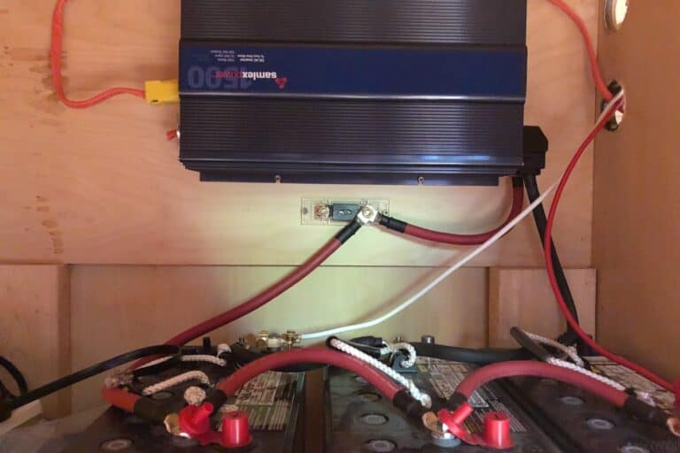 three large batteries connected to an inverter