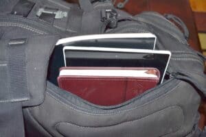 bag pockets with devices and a notebook