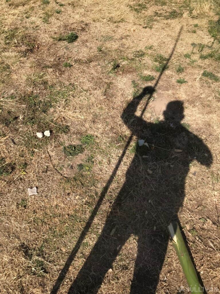 shadow of a man next to a DIY spear