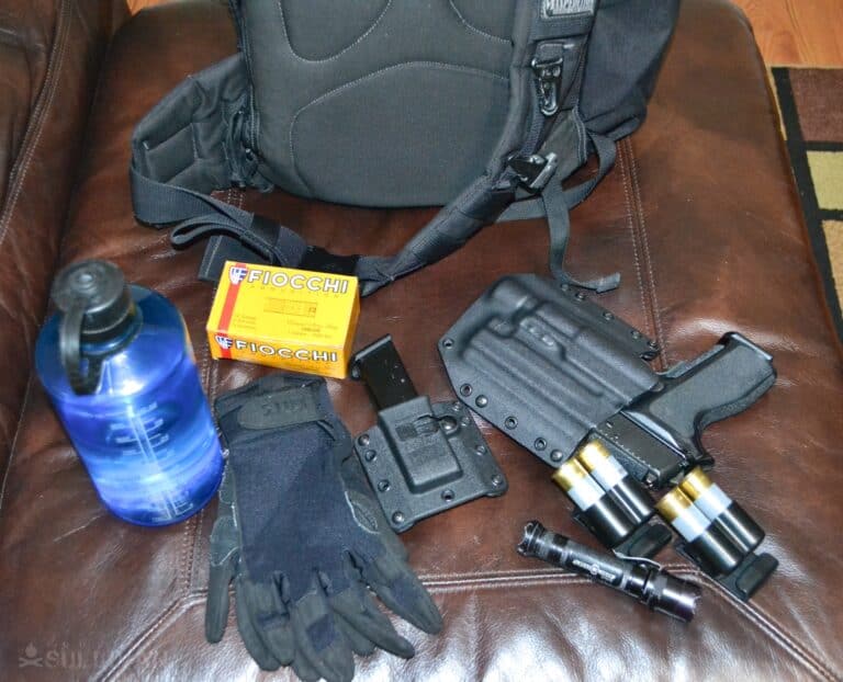 survival items next to get home bag: gloves, flashlight, water bottle, matches, and more